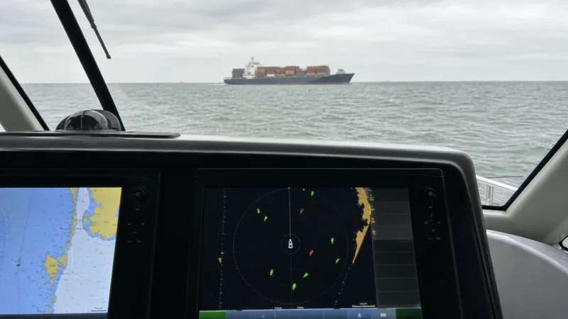 AIS targets on a yacht display with a cargo ship visible ahead